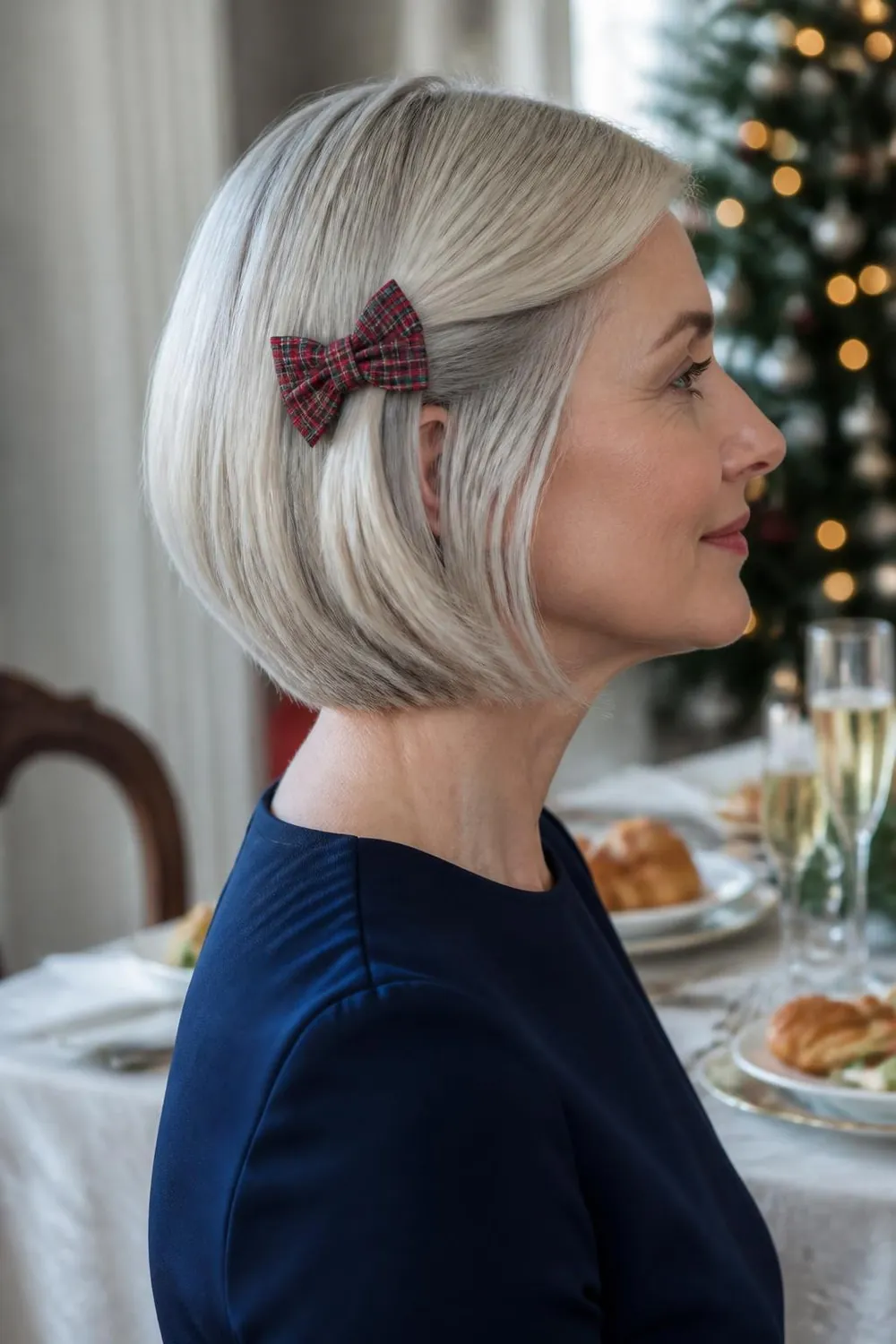 Chin-length bob with a small tartan bow clip behind one ear