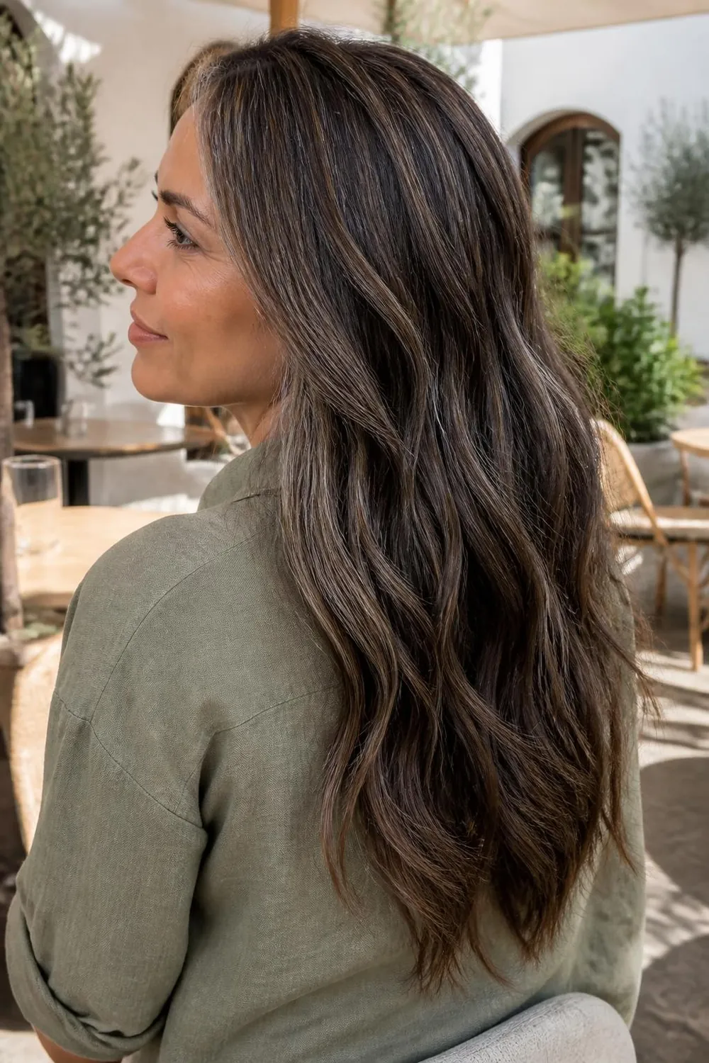 Dark brunette hair with herringbone highlights that blend natural gray into soft dimension