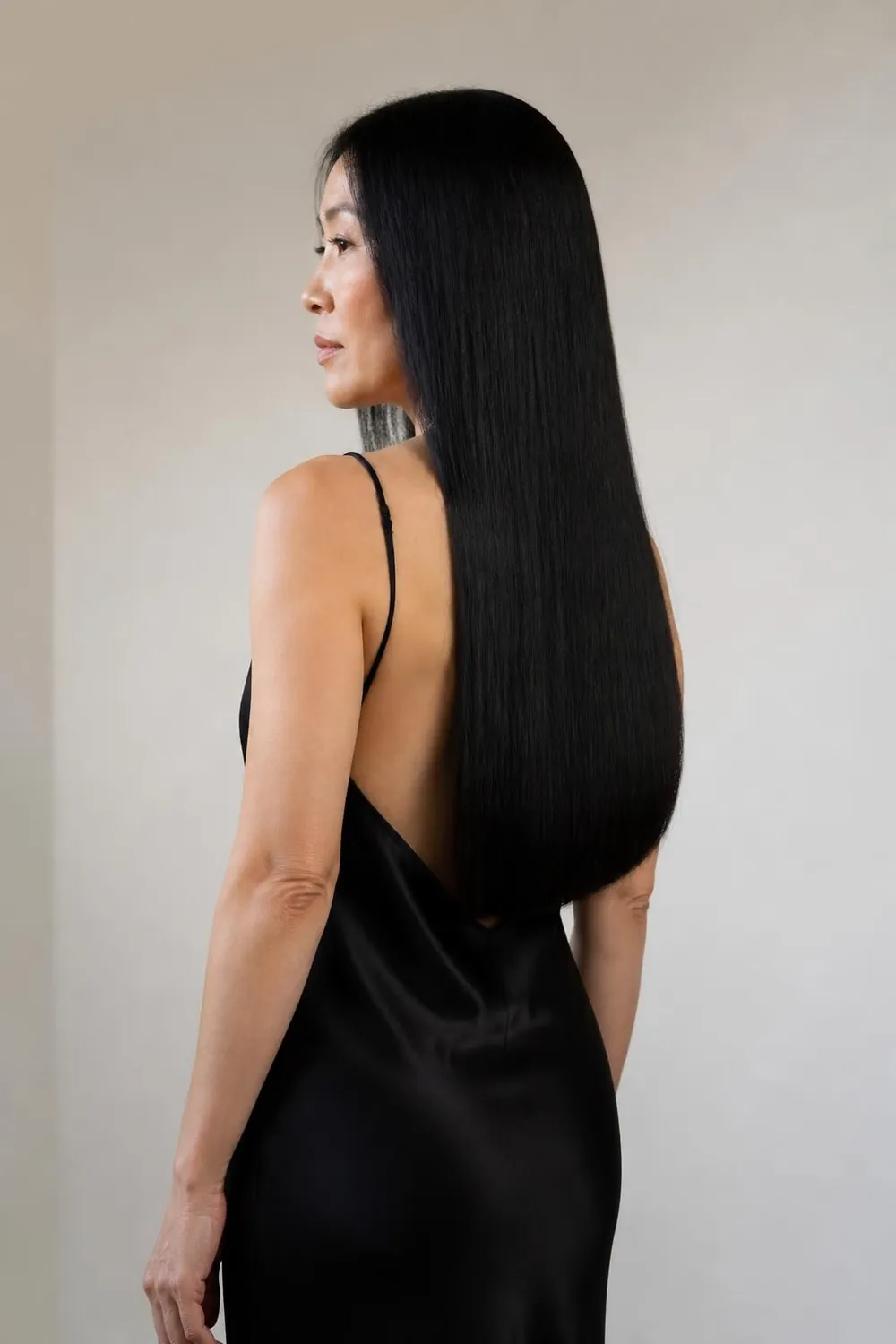Long blunt one-length cut with glossy healthy ends on a woman in her 40s