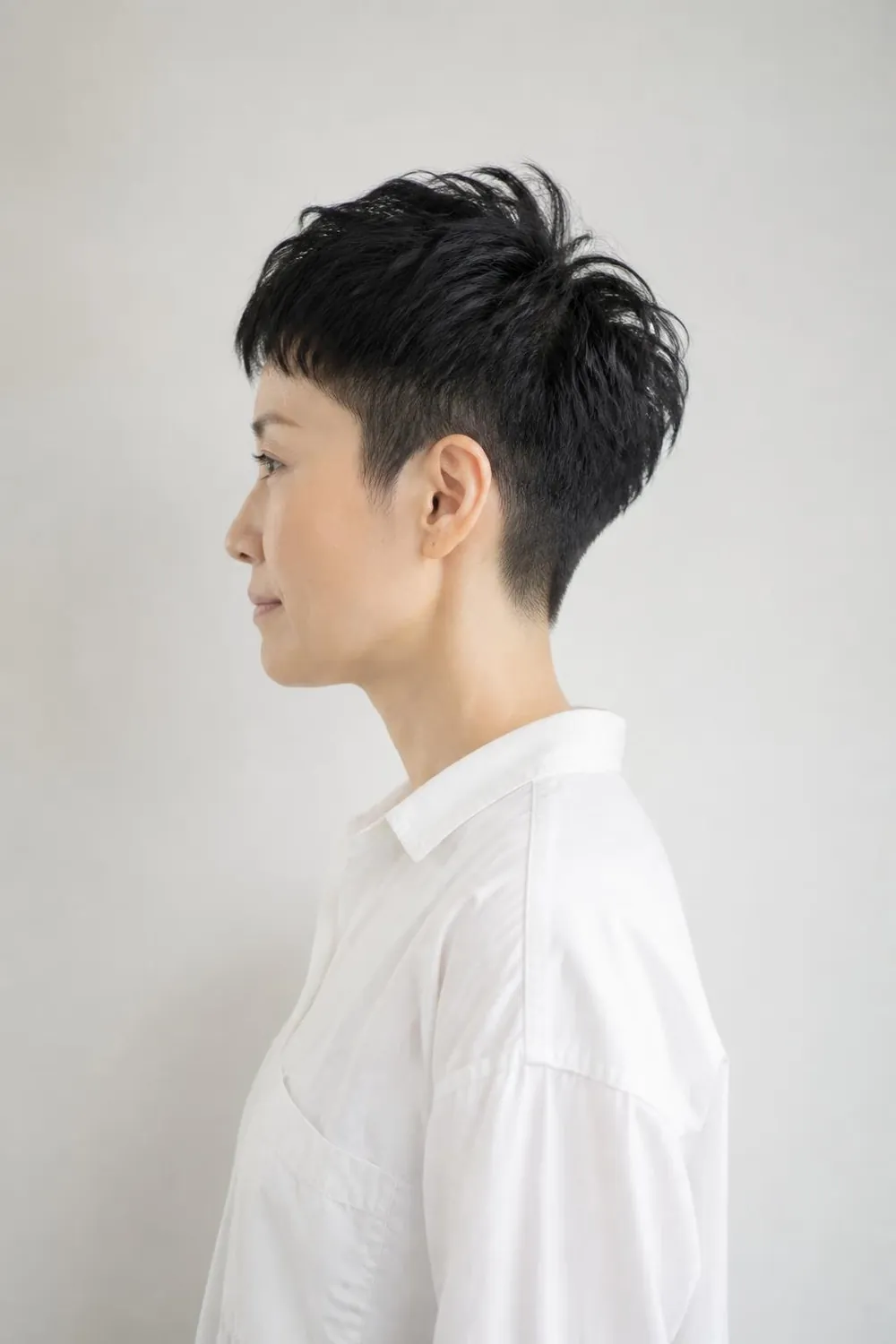 Tapered pixie with close sides and height on top for fine hair, woman in her 40s