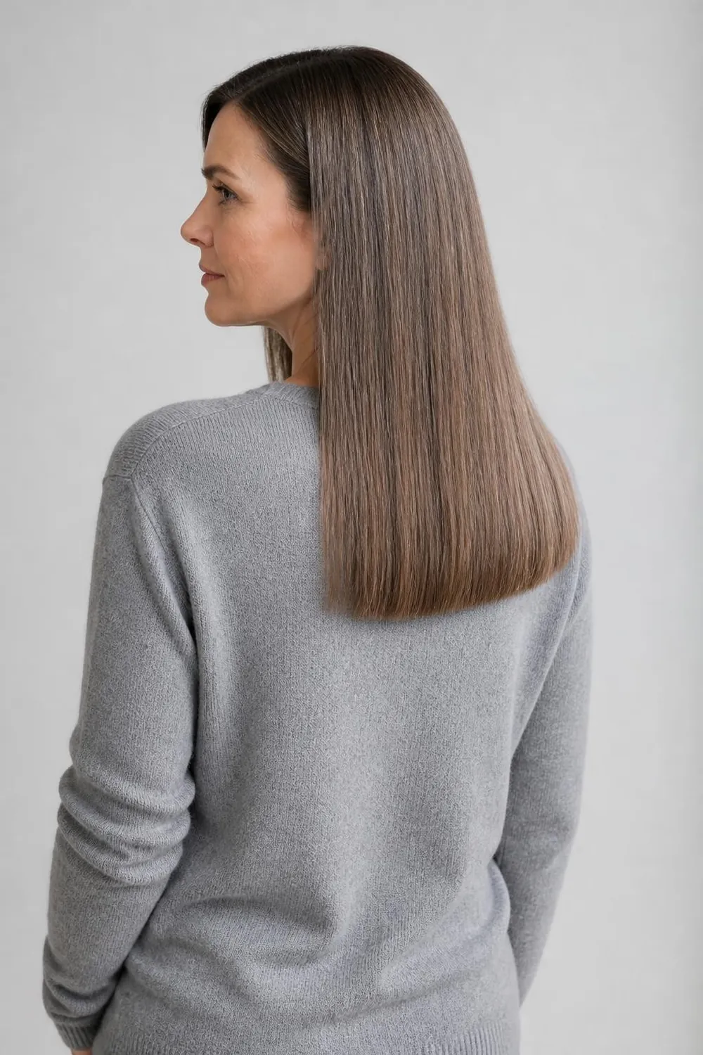 Long glossy one-length haircut for fine hair on a woman in her 40s