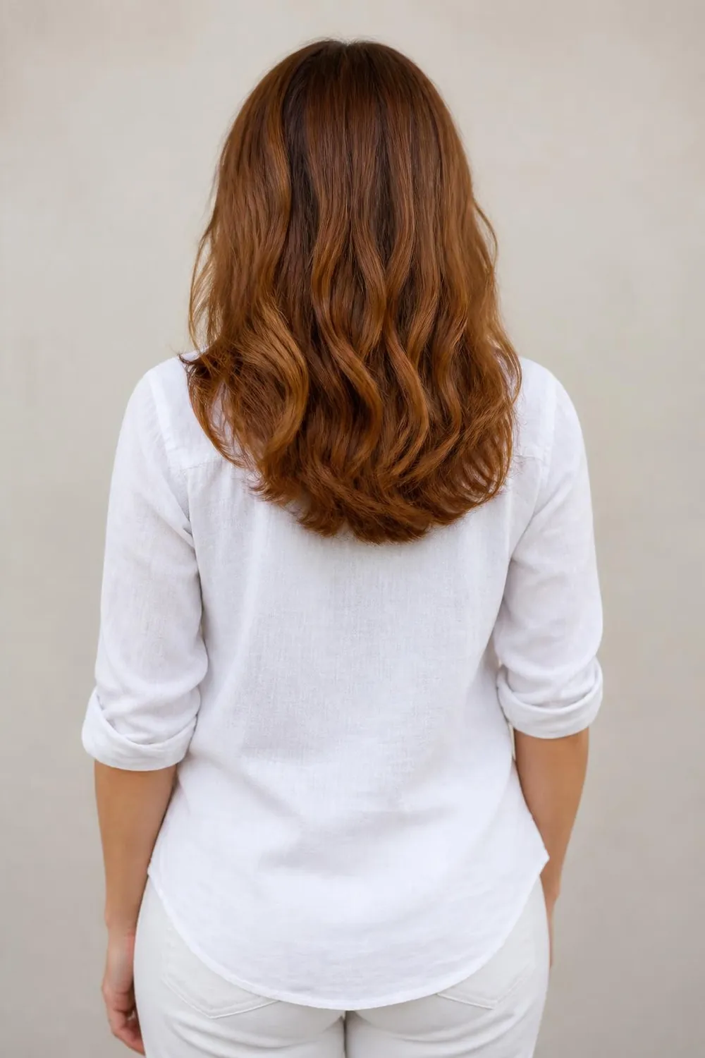 Back view of a soft rounded U-cut on medium hair, woman in her 40s