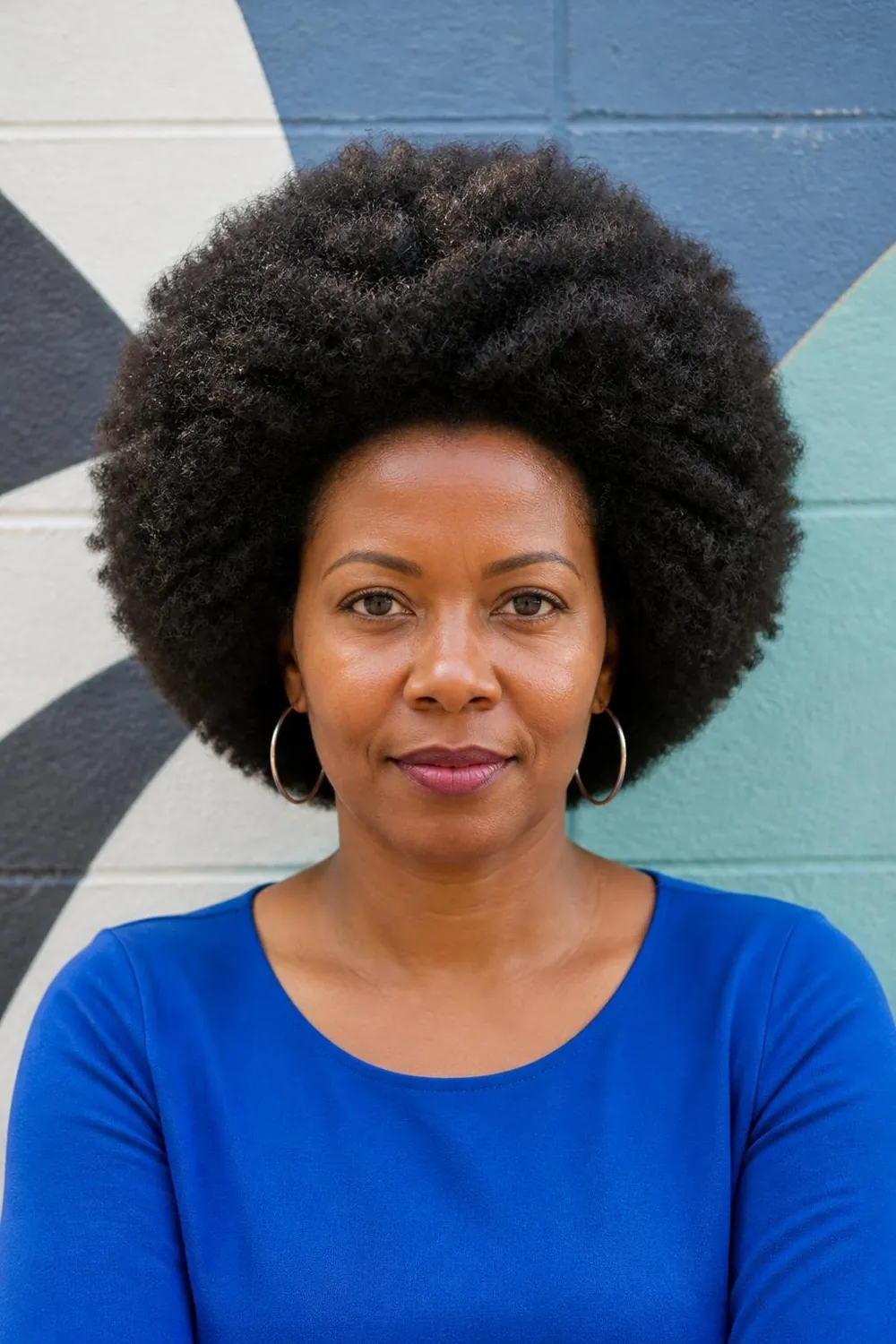 Sculpted medium afro on thick coily hair for a Black woman in her 40s
