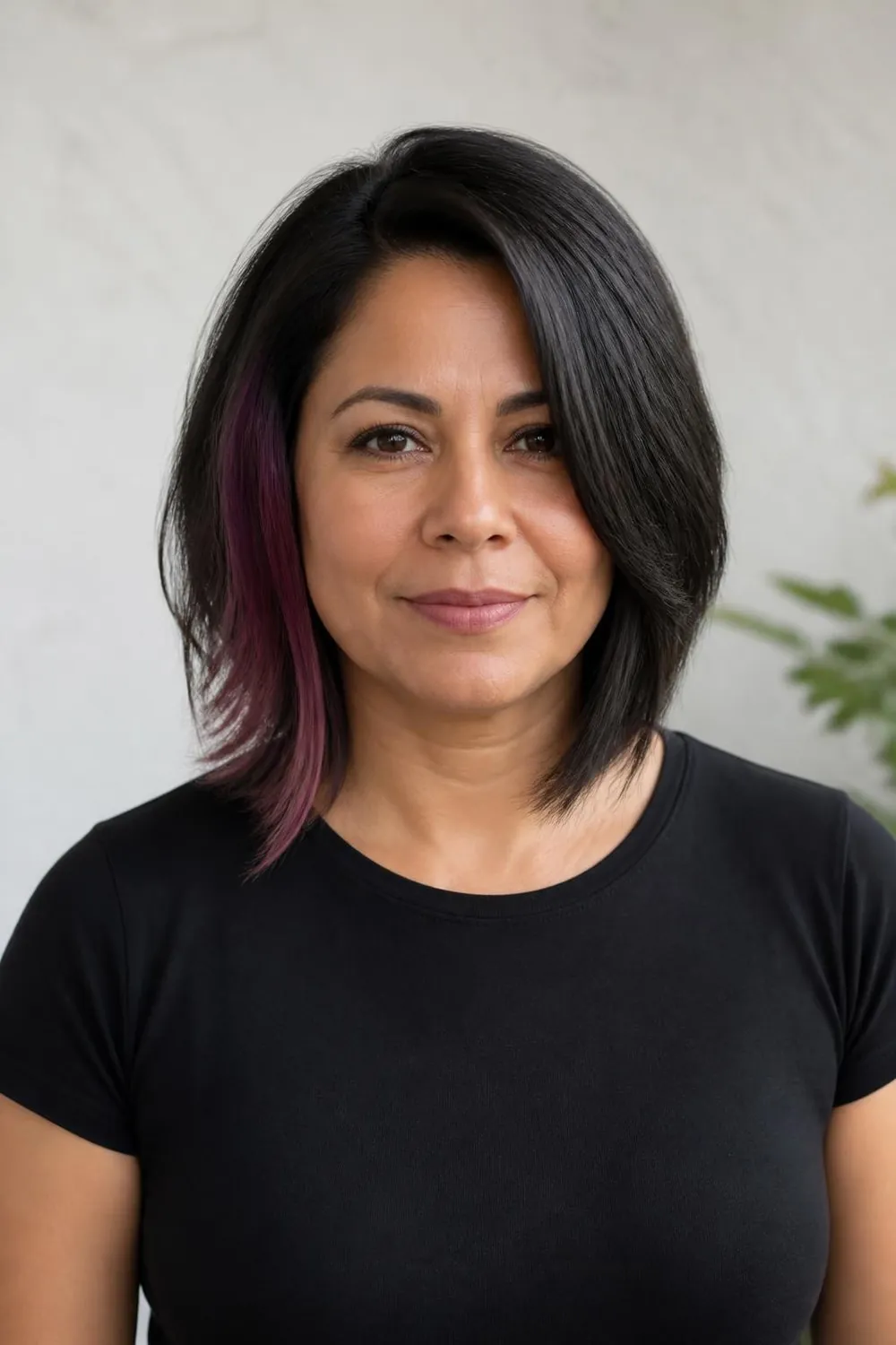 Asymmetrical collarbone cut longer on one side for a woman over 50