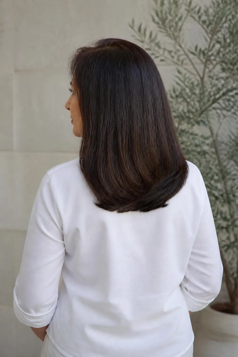 U-shaped shoulder-length cut with a curved back hemline for a woman over 50