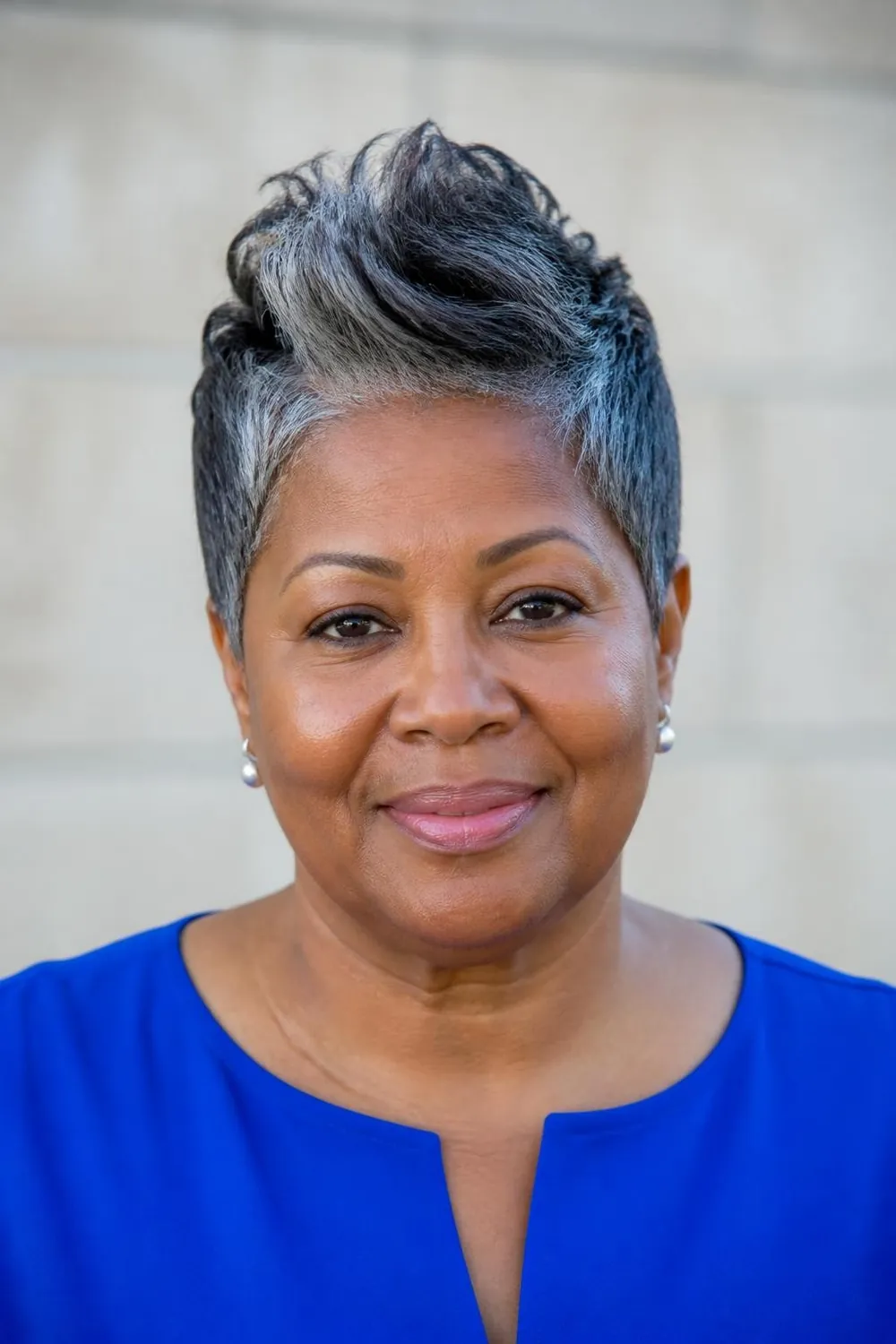 Soft faux hawk pixie with height through the center for a round face over 50