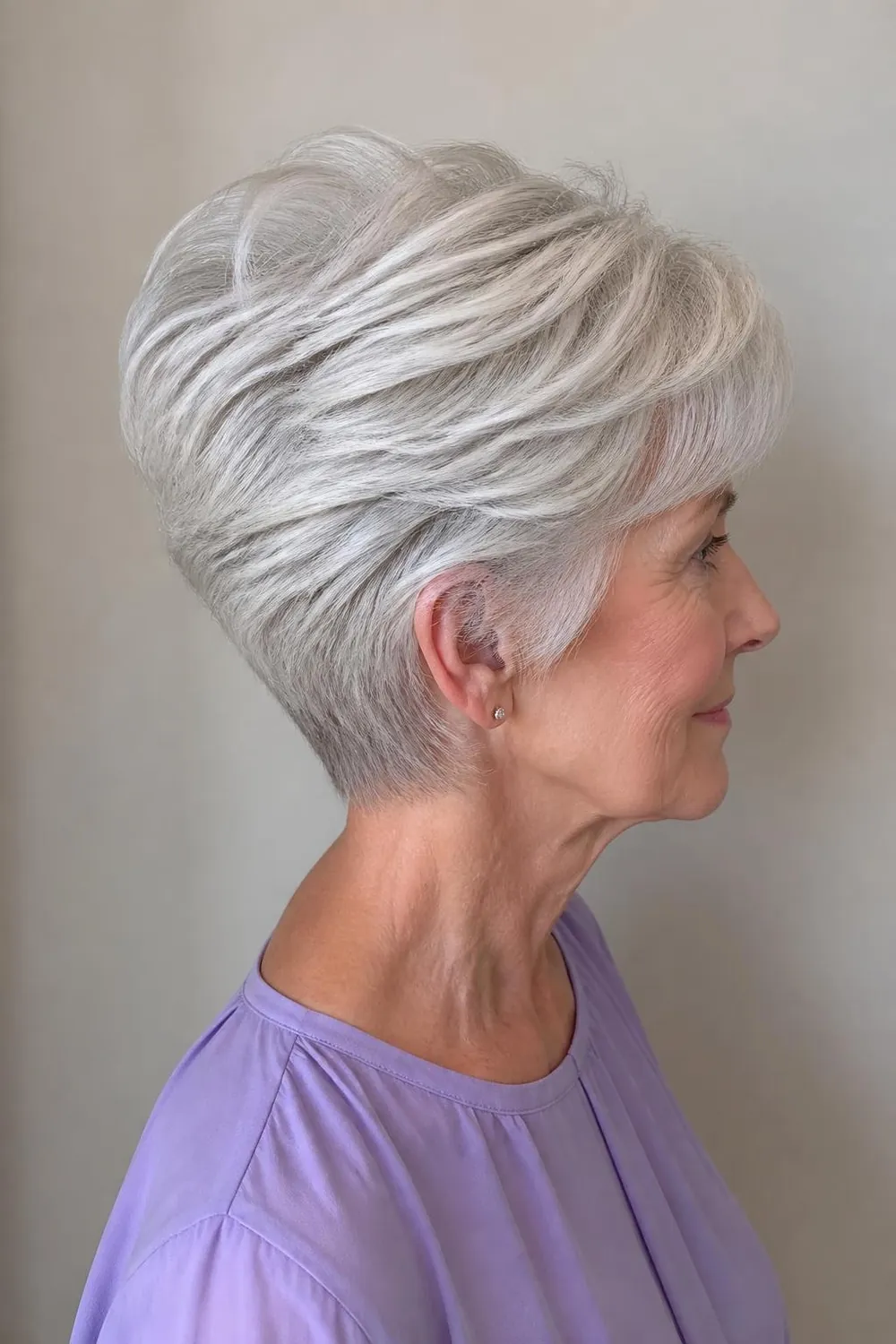 Stacked wedge haircut with graduated layers at the back for women over 60