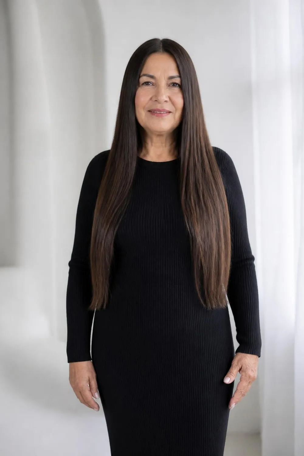Long sleek straight hair with a center part on a Latina woman over 60