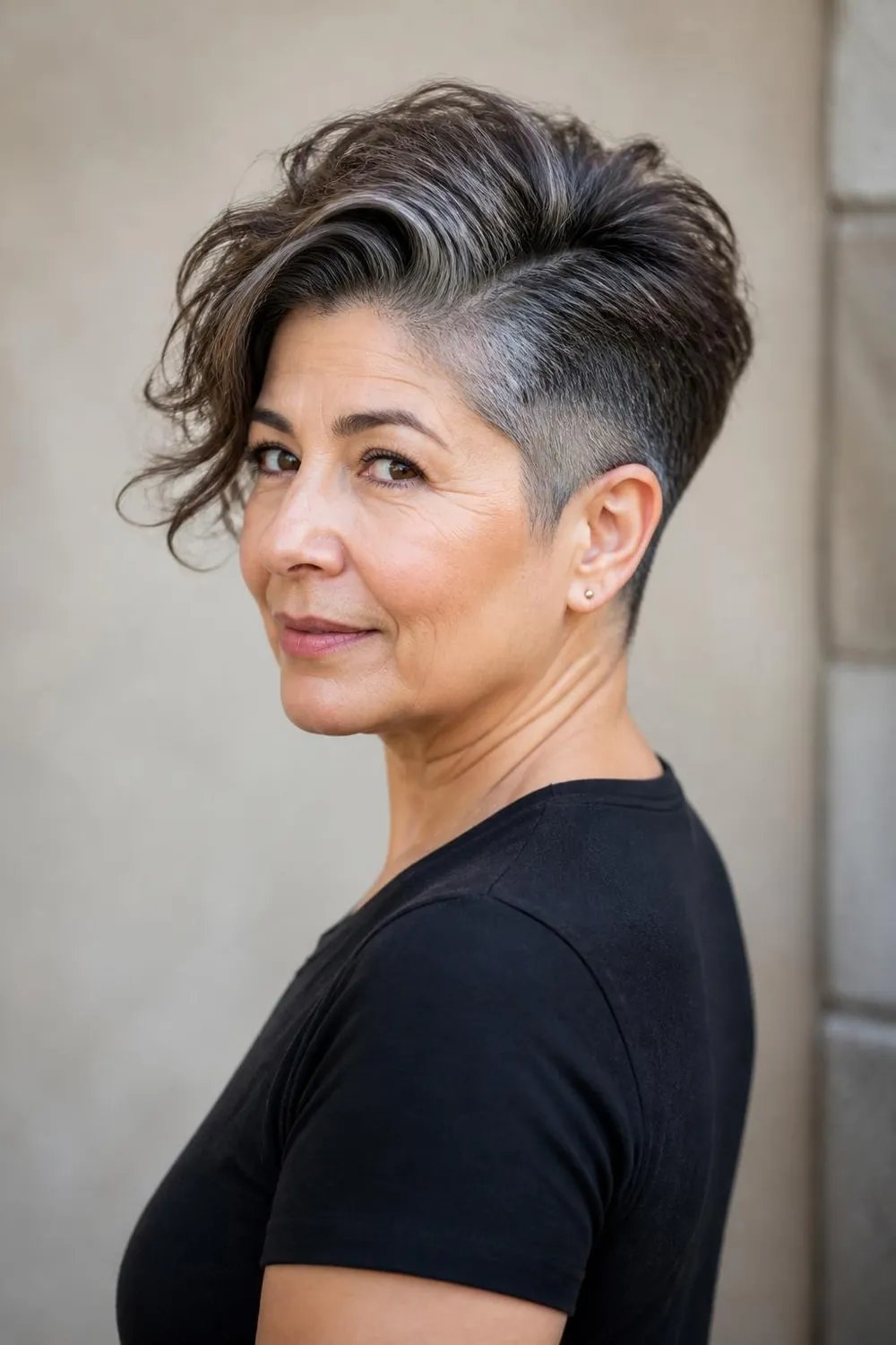 Pixie cut with a clipped undercut and longer textured top for women over 60