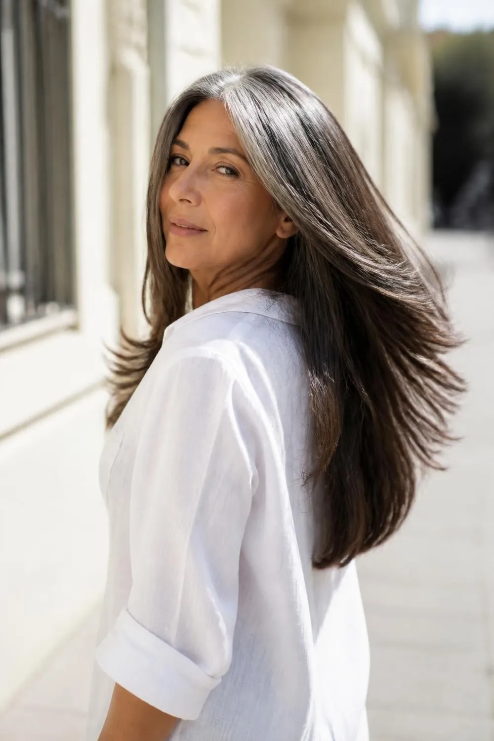 Long straight thick hair with swing layers moving freely, Latina woman in her 60s
