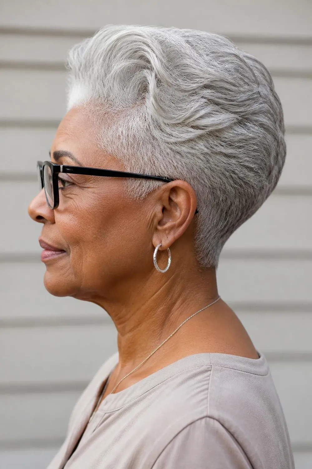Wedge haircut with smooth sides and a stacked back for women over 60 with glasses