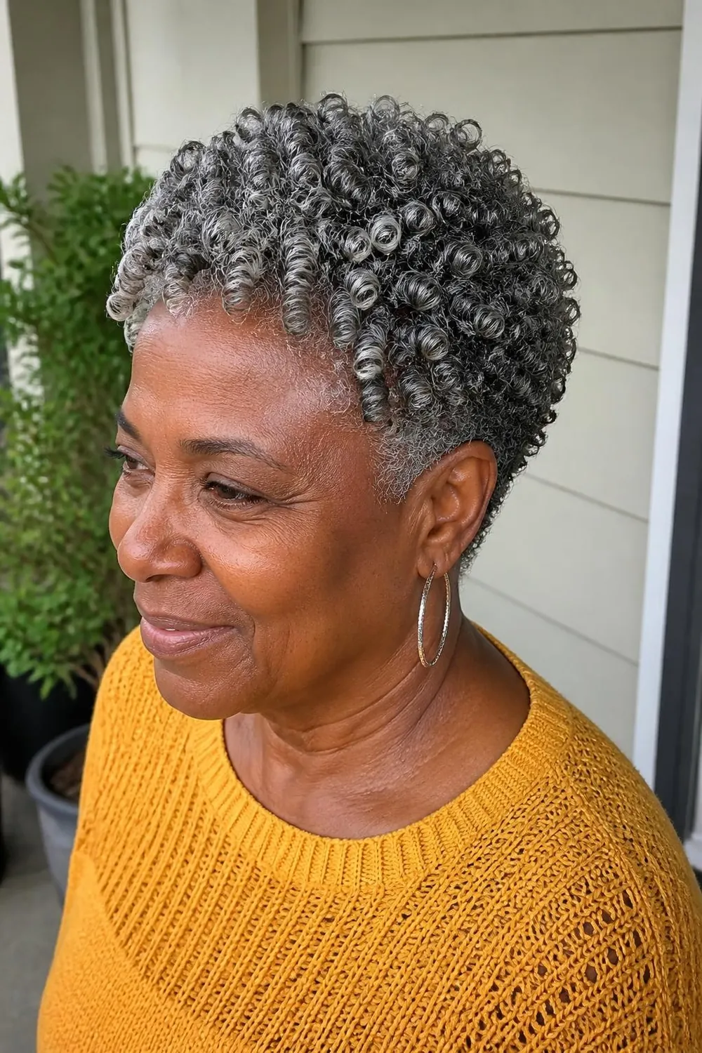 Finger coils on a short tapered natural cut, close-up, Black woman in her sixties