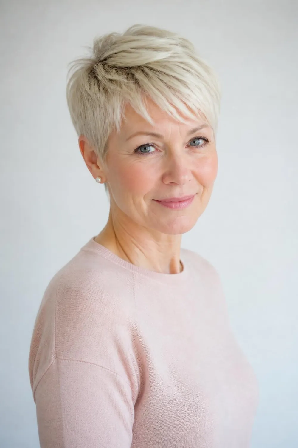 Platinum blonde pixie with soft texture on a woman over 50