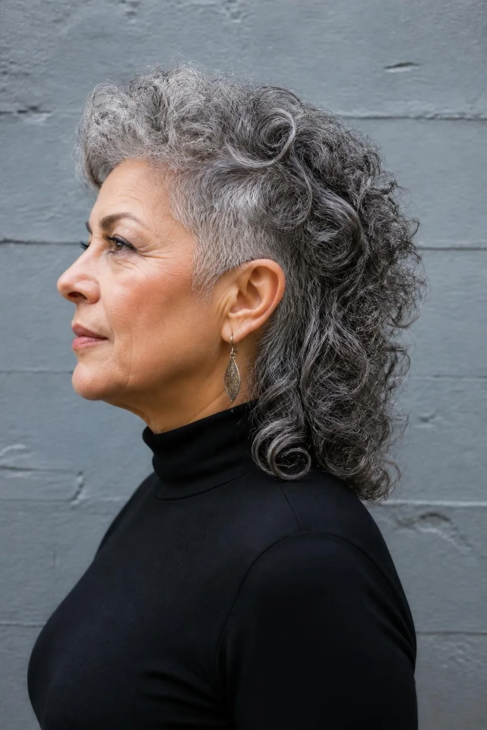 Soft curly gray mullet with short sides and longer curls at the nape