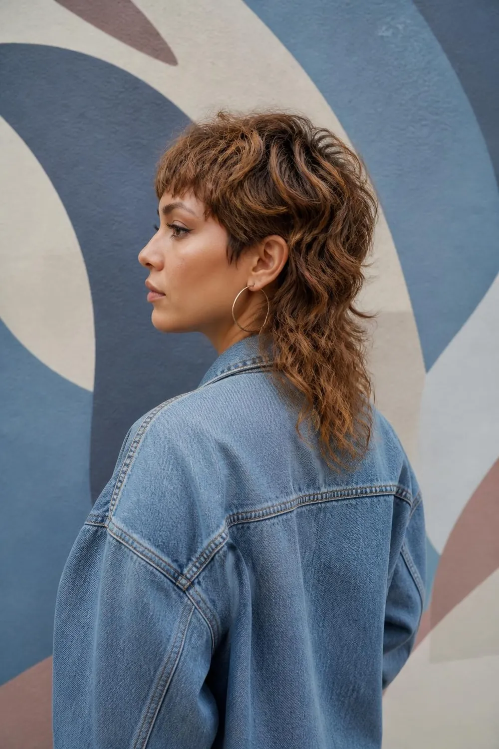 Soft modern mullet with a short textured top and longer nape for wavy hair
