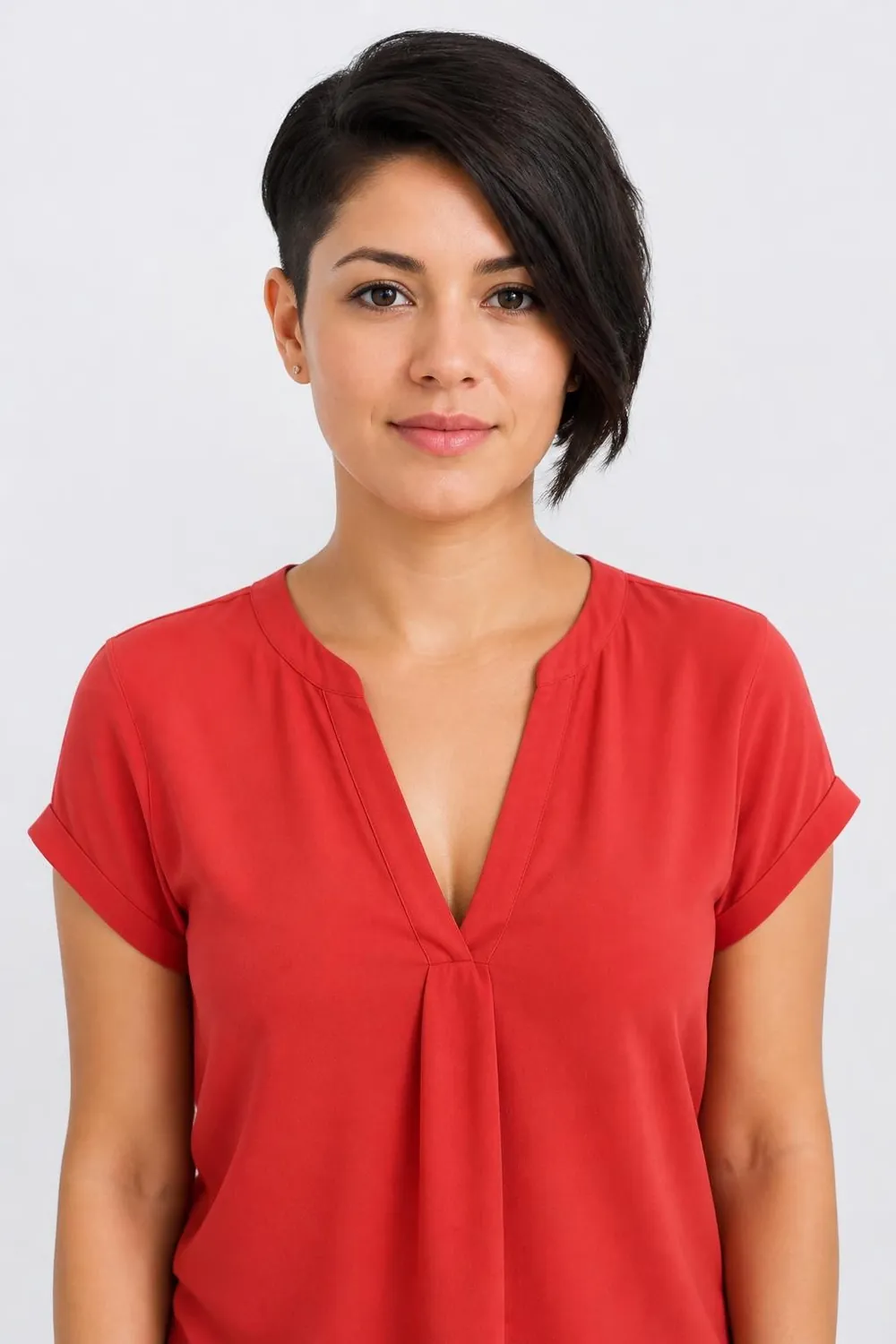 Asymmetrical pixie with one long side sweeping toward the cheek for round or square faces