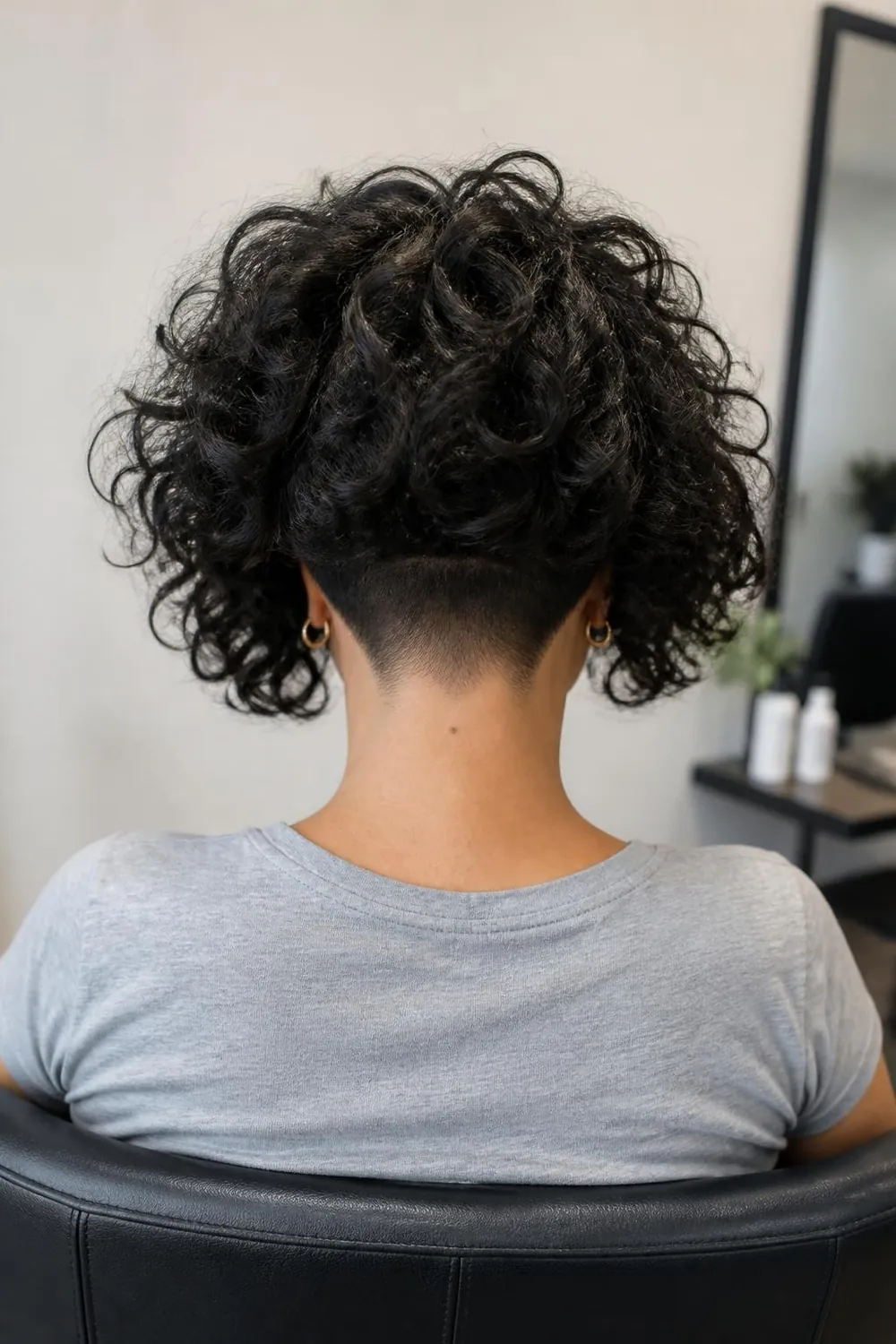Undercut curly bob with a hidden shaved nape for thick curly hair