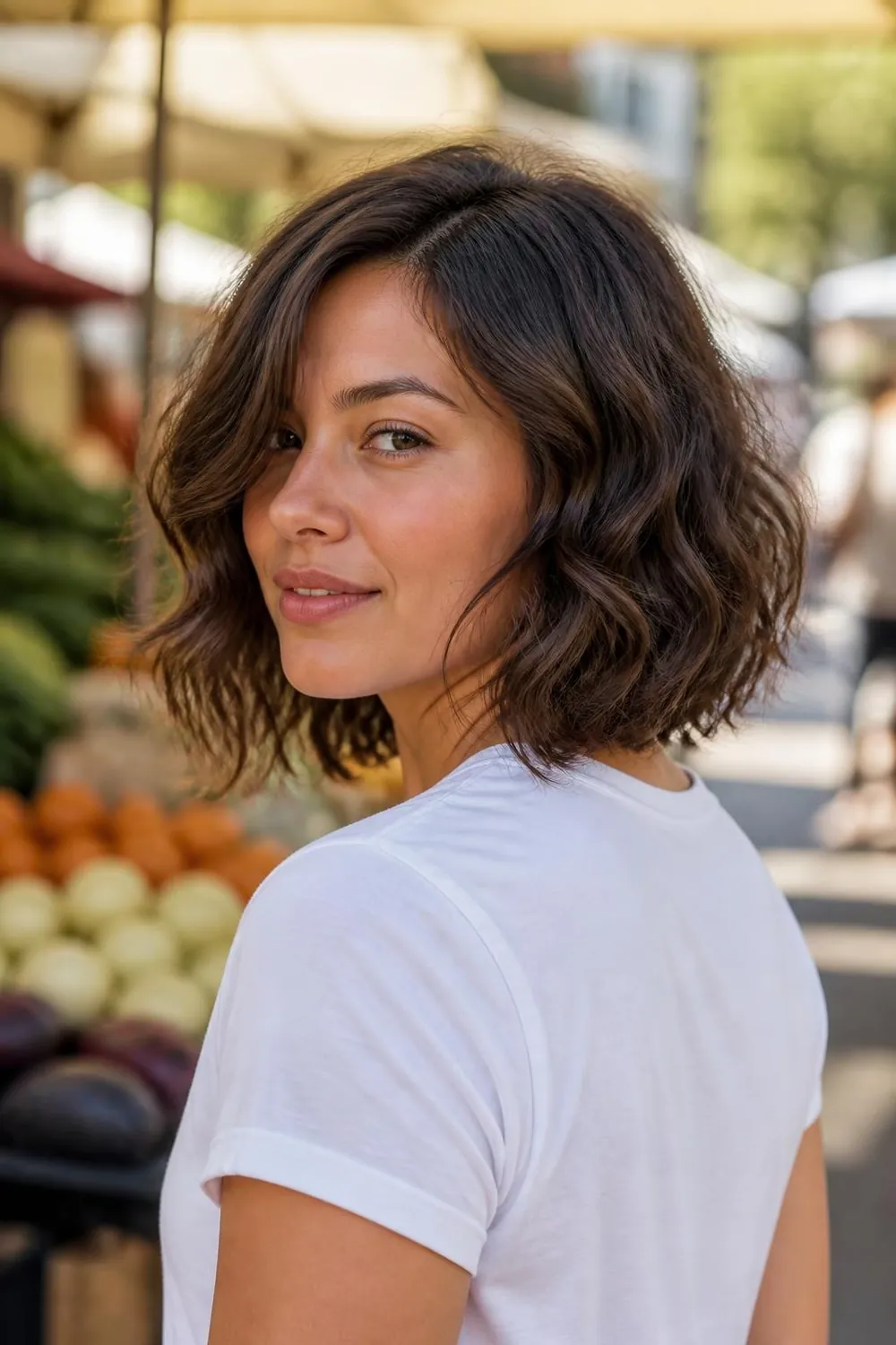 Wavy shag bob with tousled layers and a side part for round faces with wavy hair