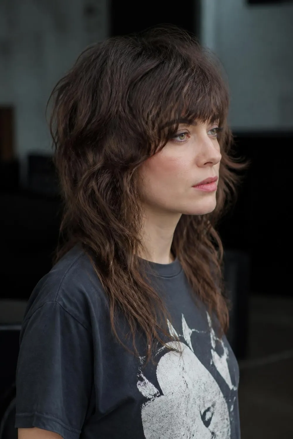 Short wolf cut with heavy shaggy bangs and a layered crown for thick hair