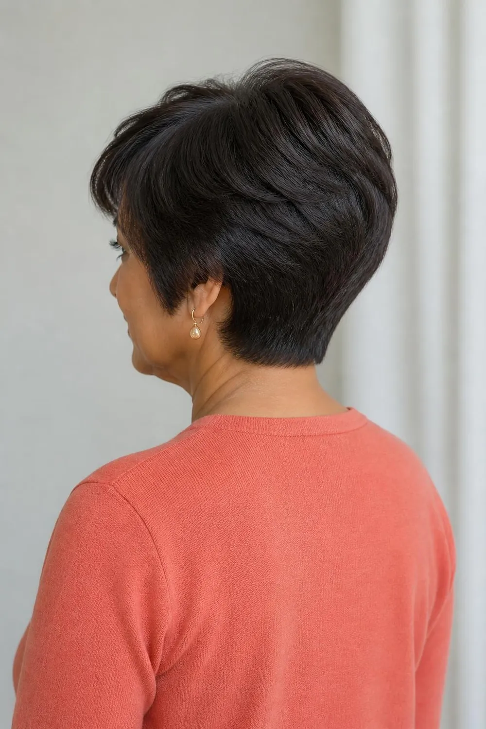 Short wedge haircut with stacked rounded layers and a full crown for fine hair